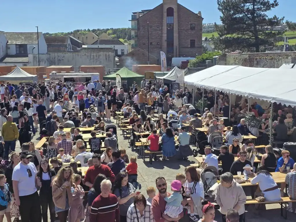 Crowds at long tables at Eat Street Cumbria in the sunshine