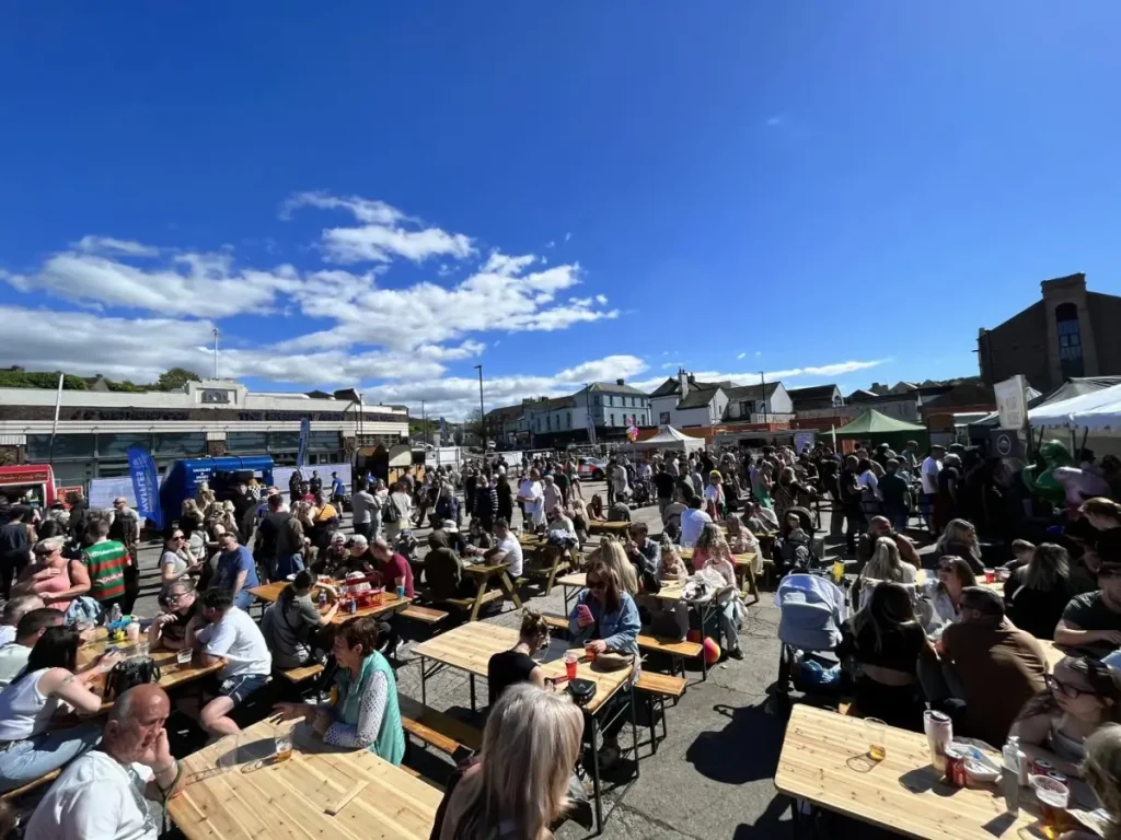 Crowds of people eating at Eat Street Cumbria at picnic tables